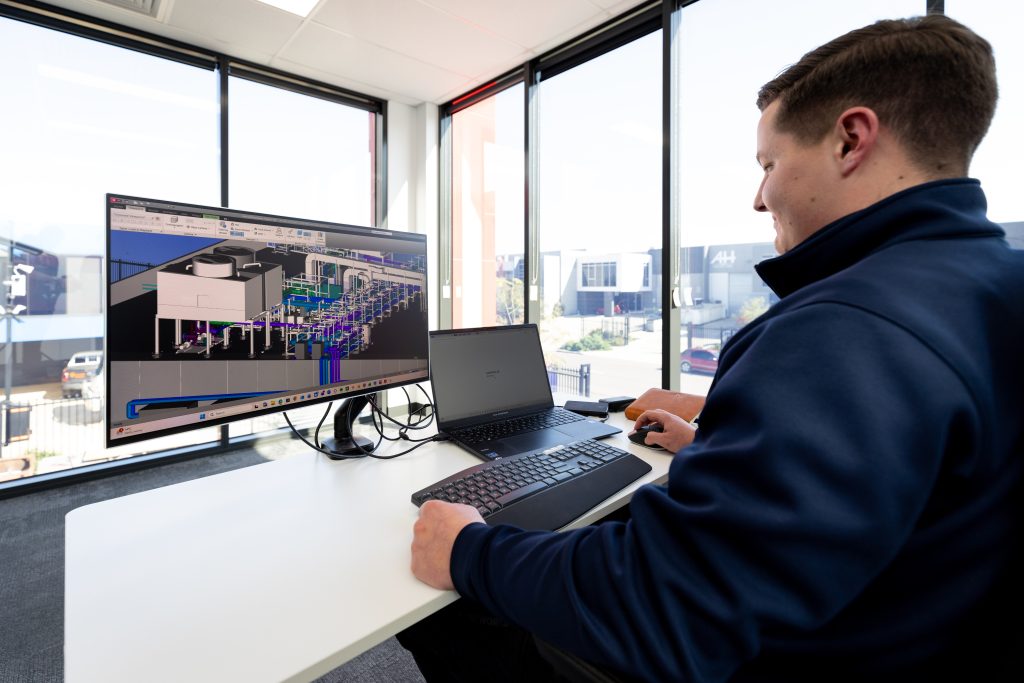 Eurofast team member reviewing a building-services model.